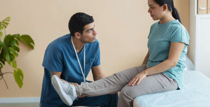 doctor-helping-patient-rehabilitation